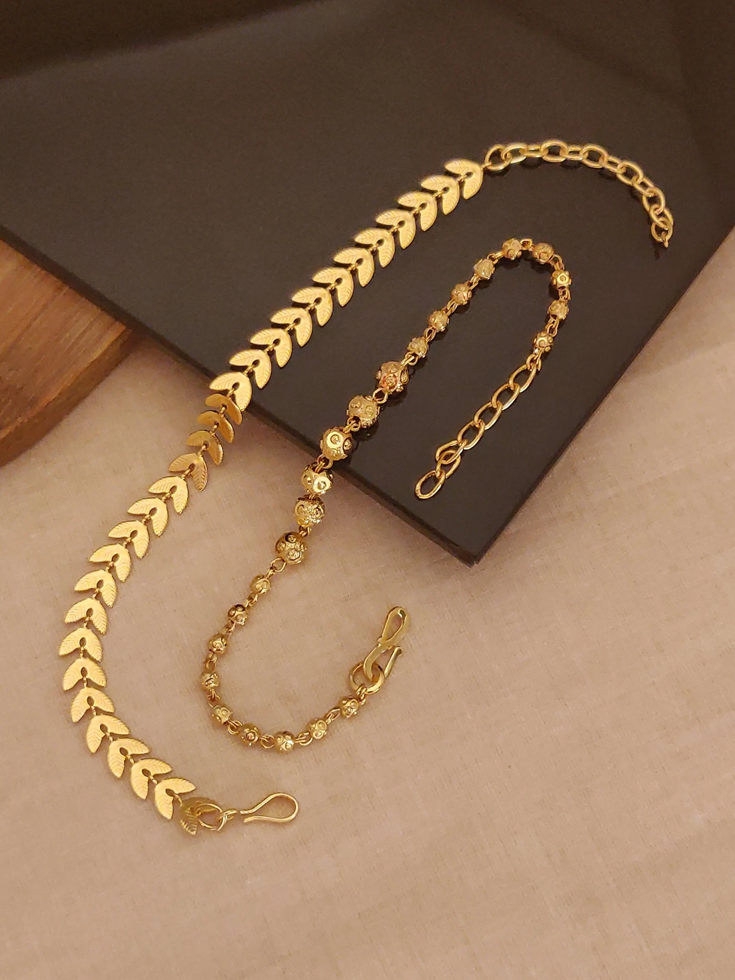 Golden bracelets on a brown surface