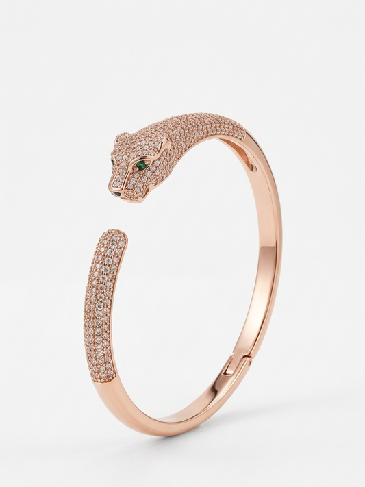 Rose gold bracelet with panther design on a white background