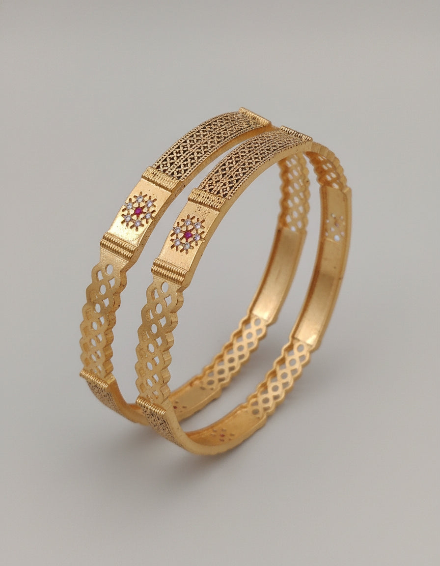 Gold Bangle with intricate design on a gray background