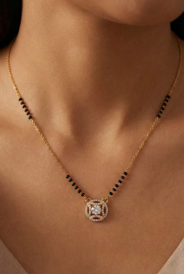Gold necklace with a pendant on a person's neck