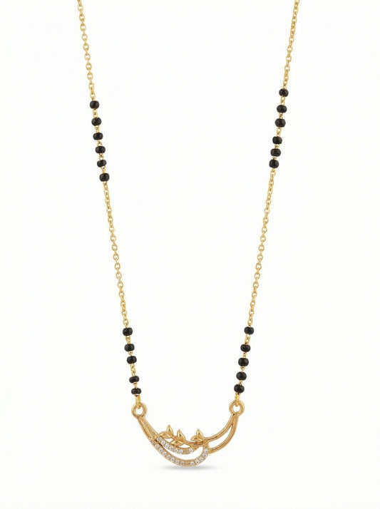 Necklace with black beads and gold chain on a white background