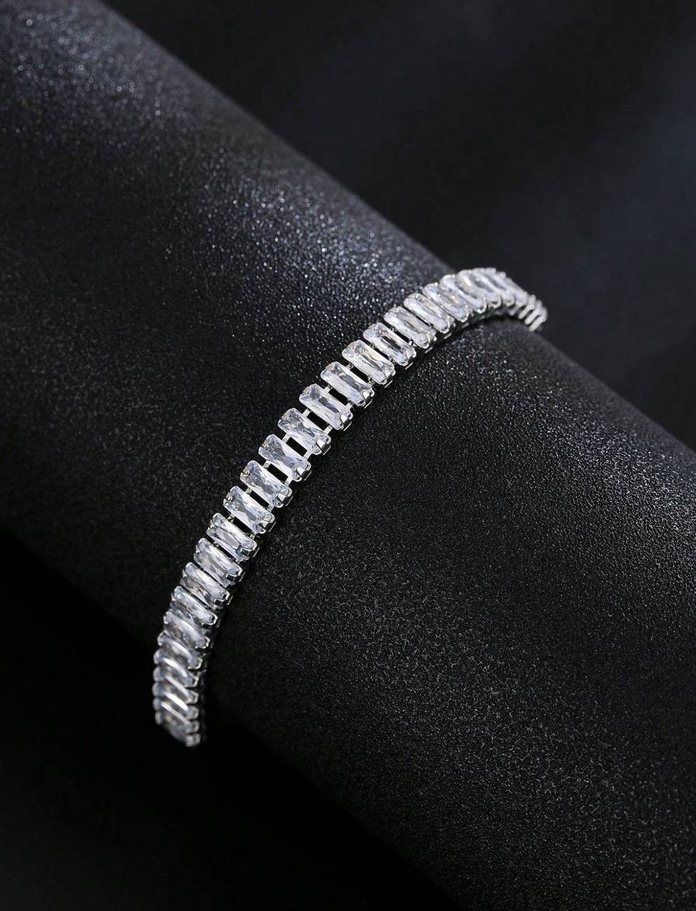 Silver bracelet on a black surface