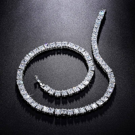 Square-cut diamond look tennis bracelet on a woman’s wrist in natural light