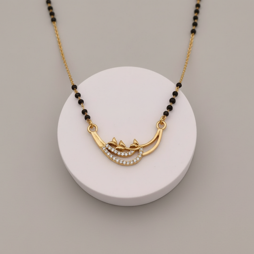 Gold necklace with black beads on a white round base