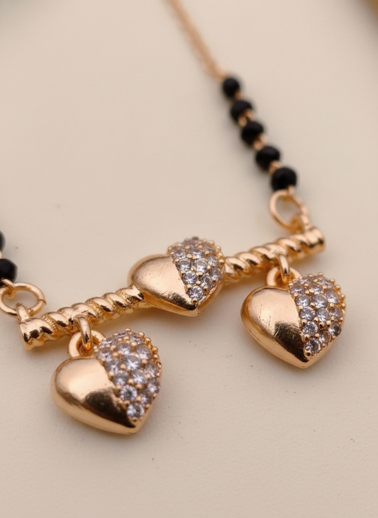Necklace with heart-shaped pendants on a beige background